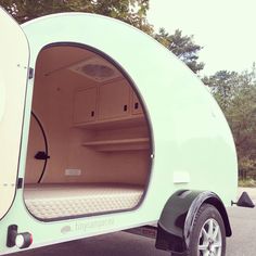 an empty camper trailer with its door open