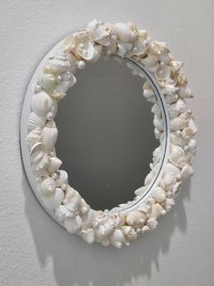 there is a mirror made out of seashells on the wall