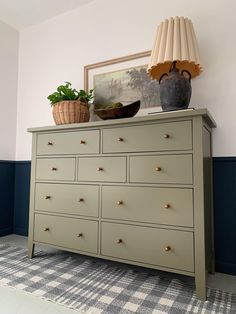 a dresser with two vases on top of it