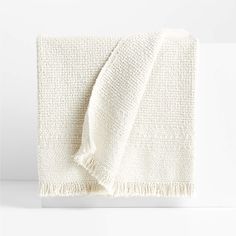 a white blanket with fringes on it