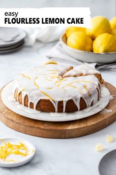 a lemon cake sitting on top of a wooden cutting board