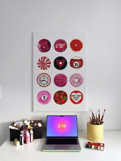 a laptop computer sitting on top of a white desk