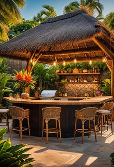 an outdoor bar with stools under a thatched roof and palm trees surrounding it