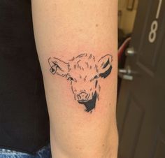 a cow's head is shown on the left side of the arm, with black ink