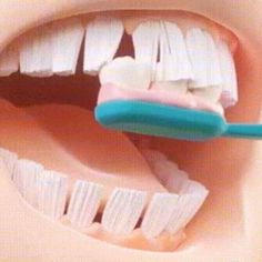 a toothbrush is being used to brush the teeth