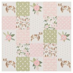 a pink and green patchwork quilt with flowers on the front, an animal - themed design