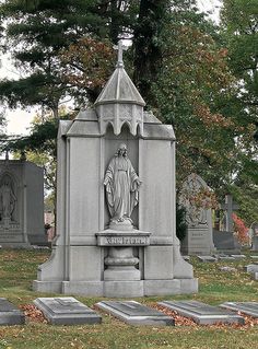 a cemetery with headstones and tombstones in the grass