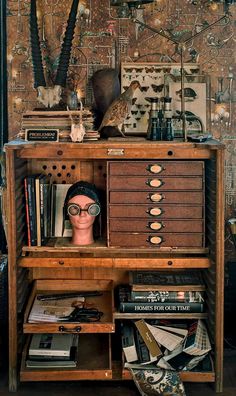 an old wooden cabinet with many items on it