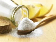 a wooden spoon sitting next to a jar filled with sugar