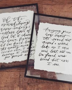 two pieces of paper with writing on them sitting next to each other in black frames