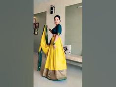 a woman in a yellow and green sari