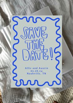 a save the date card on top of a bed