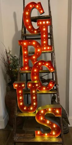 a ladder that has some light up letters on it