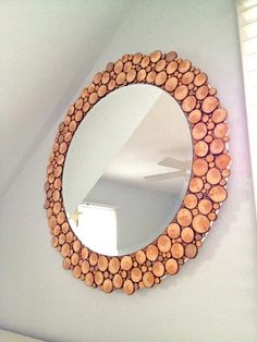 a mirror made out of wood is hanging on the wall