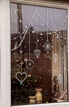 a window decorated with christmas decorations and ornaments