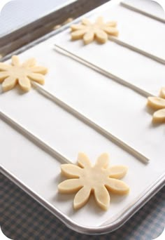 the cake is decorated with flowers and sticks