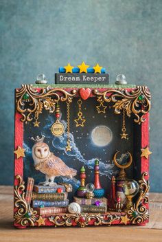 an owl sitting on top of a wooden table next to books and other things in front of it