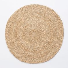 a round jute rug on a white background