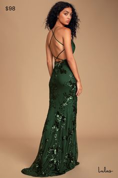 a woman in a green dress is standing back to back with her hands on her hips