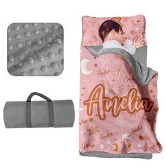 a blanket and pillow with an image of a baby sleeping on it, both in pink