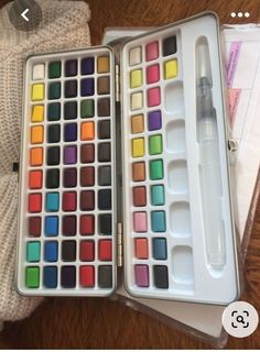 an artist's palette and watercolors in a box