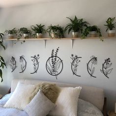 a bed topped with lots of plants next to a wall mounted on it's side