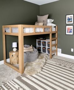 a loft bed with a desk underneath it in a room that has carpet on the floor