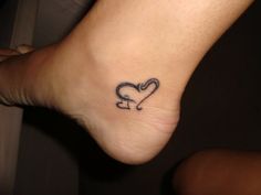 a foot with a heart tattoo on it