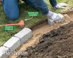 a man laying on the ground next to a pile of dirt with tools in it