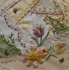 an embroidered piece with flowers and butterflies on it