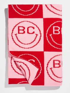 a red and white blanket with the bc logo on it