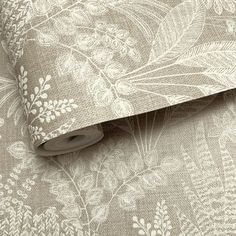 an image of a wallpaper with white flowers and leaves on the fabric, as well as a roll of tape