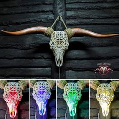 an animal skull with long horns is lit up in different colors and patterns on the wall