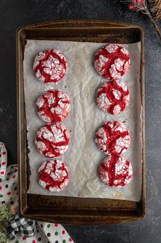 red velvet cookies on a baking sheet with sprinkles