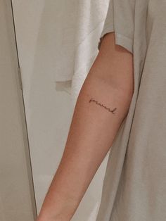 a person with a small tattoo on their arm