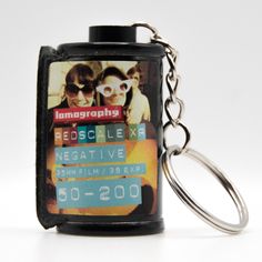 a keychain with an image of two people on the front and back of it