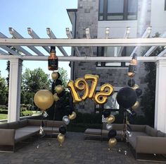 an outdoor party with balloons and decorations