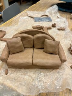 a couch made out of clay sitting on top of a table