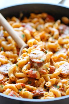 a skillet filled with pasta and sausage