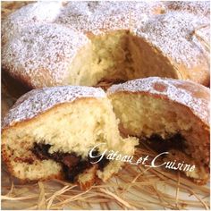 a cake with powdered sugar on top is cut in half