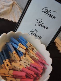 a bowl filled with clothes pins next to a sign