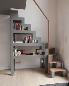 there is a book shelf under the stairs