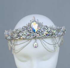 This stunning Mermaid Crystal Crown is a mesmerizing headpiece perfect for fantasy weddings, cosplay, or special occasions.  Designed with iridescent crystals, shimmering rhinestones, and intricate metalwork, this tiara captures the ethereal beauty of the ocean.  Ideal for brides, festival-goers, and lovers of boho style, the crown's sparkling elements reflect light in a rainbow of colors, creating a magical, captivating look.  The design is lightweight, comfortable, and adjustable, making it easy to wear all day. Lunar Wedding, Ocean Crown, Sea Crown, Mermaid Tiara, Steampunk Book, Beach Bachelorette Party, Wedding On The Beach, Mermaid Stuff, Queen Jewelry