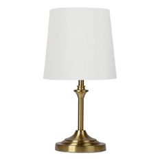 a gold table lamp with a white shade