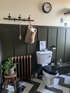 a bathroom with black and white tile flooring next to a wall mounted radiator