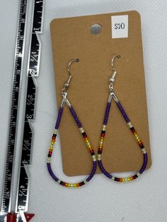 Beaded teardrop with French hooks. Teardrop Earrings With Fish Hook, Teardrop Fish Hook Earrings, Multicolor Teardrop Hoop Earrings With Dangling Beads, Purple Dangle Teardrop Earrings With Ear Wire, Adjustable Beaded Teardrop Earrings, Colorful Beaded Dangle Teardrop Earrings, Teardrop Earrings With Round Beads, Long Drop Teardrop Earrings With Dangling Beads, Purple Teardrop Earrings With Dangling Beads