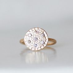 "Diamond \"Flower Center Ring\". I designed this sparkly diamond ring to look like the center of a wildflower. 7 sparkly diamonds are sprinkled around the handmade disc ring. I gave the band a subtle hammered texture. What a treasure! Disc - about 1/2\" in diameter Diamonds - 1.9mm's each, natural brown color (champagne) Made to order Also available in 18k yellow gold, 14k rose gold and sterling silver. *Non U.S. buyers - please read my shop policies for information regarding possible import tax Disc Ring, Gold Coin Ring, Alternative Engagement Ring, Shiny Objects, Coin Ring, Color Champagne, Flower Center, Gold Coin, Alternative Engagement Rings