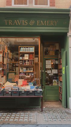 a book store with lots of books on the shelves and in the front window that reads travis & emery