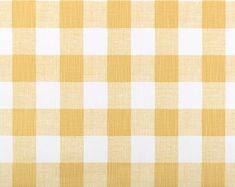 a yellow and white checkered fabric with a ruler