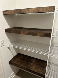 an empty pantry with shelves and shelving in the corner next to a white wall